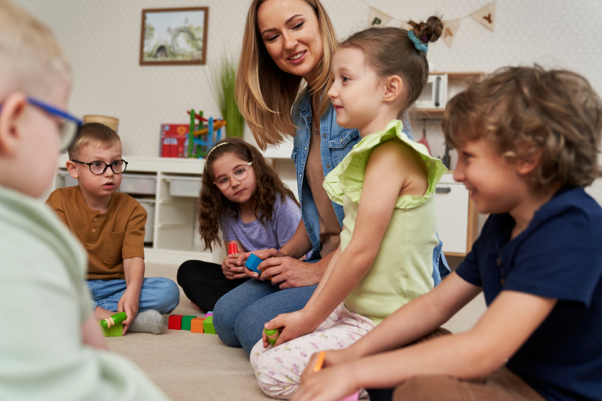 Teacher performs exercises to the children